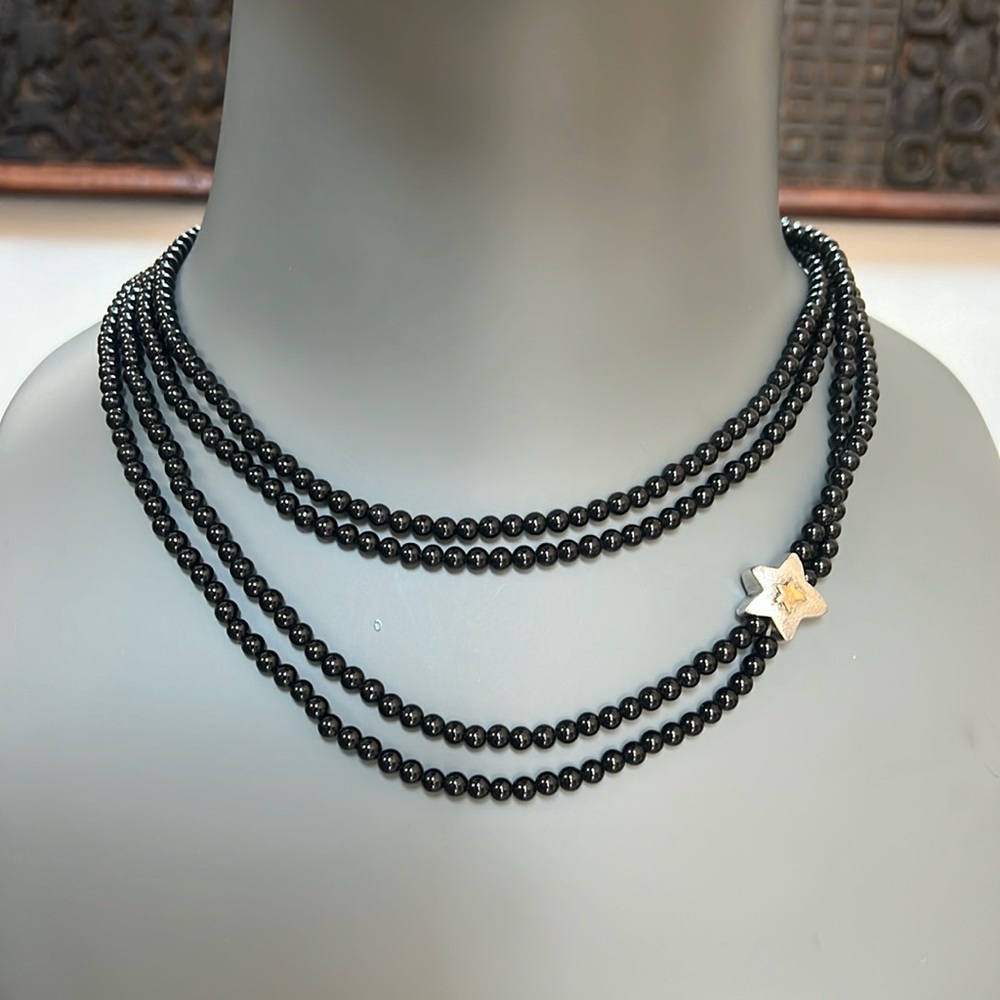 Infinity beaded necklace with a star charm detail in it black small beads
